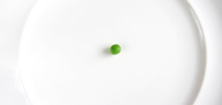A single pea on a plate